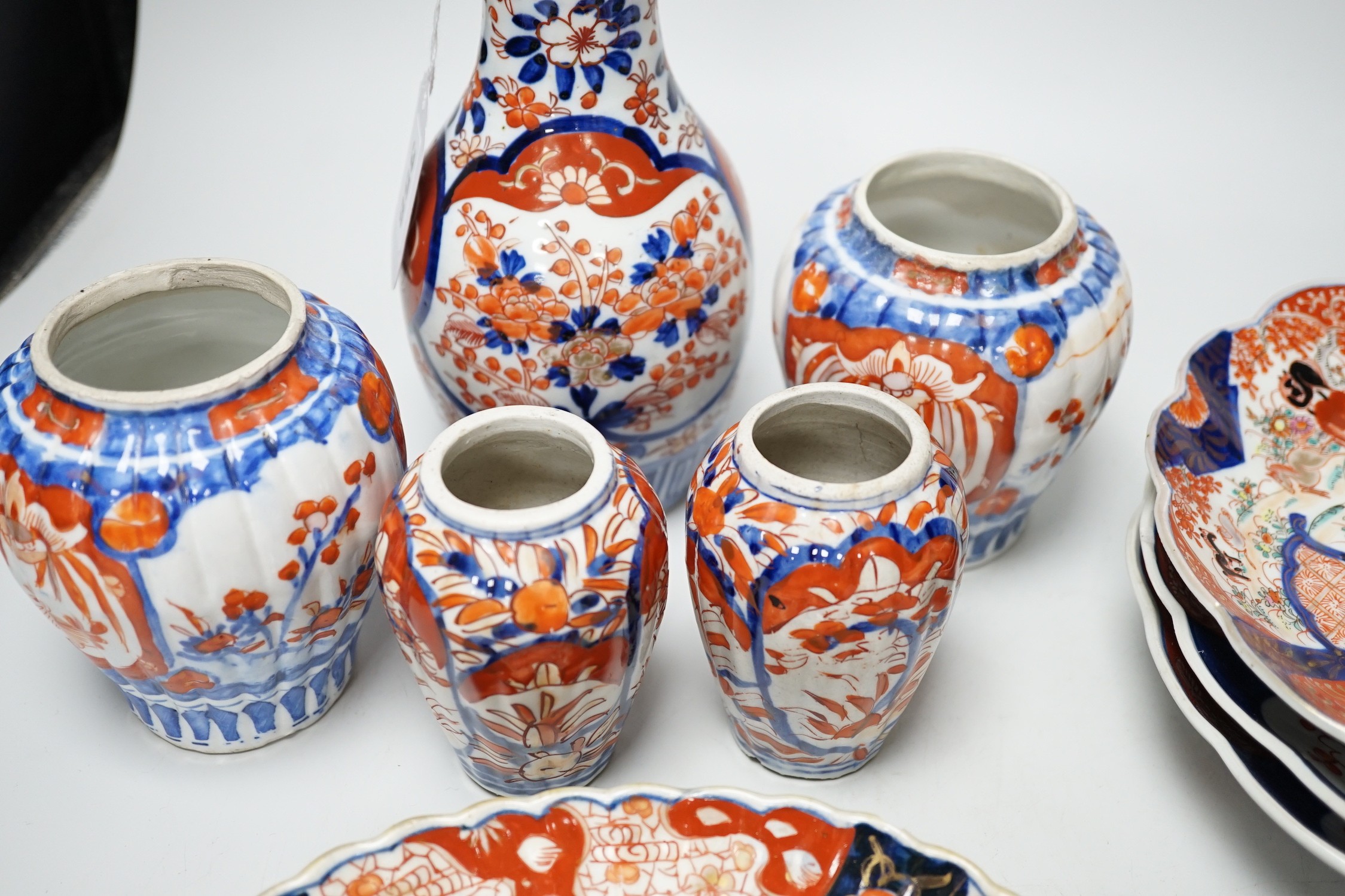A group of Imari vases and dishes, tallest 19cm